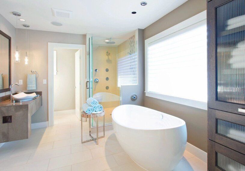 A bathroom with a large tub and shower.